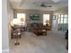 Living room with sliding doors to lanai and ample seating at 10970 Sw 69Th Cir, Ocala, FL 34476