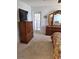 Primary bedroom with a dresser, TV, and access to a private patio at 10970 Sw 69Th Cir, Ocala, FL 34476