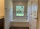 Bathroom with a garden tub and natural light from a window at 2030 Sw 163Rd Pl, Ocala, FL 34473