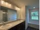 Double vanity bathroom with granite countertop and a soaking tub at 2030 Sw 163Rd Pl, Ocala, FL 34473