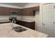 Modern kitchen boasts dark brown cabinets, granite countertops, and stainless steel appliances at 2030 Sw 163Rd Pl, Ocala, FL 34473