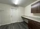 Laundry room with built-in cabinets and granite countertop at 2030 Sw 163Rd Pl, Ocala, FL 34473