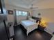 Main bedroom with king-size bed, dark wood floors, and nautical decor at 730 Ne 18Th Ave, Ocala, FL 34470