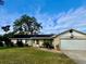 Ranch style home with stone accents and mature landscaping at 730 Ne 18Th Ave, Ocala, FL 34470