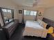 Main bedroom with king-size bed and en-suite bathroom access at 730 Ne 18Th Ave, Ocala, FL 34470