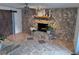 Living room with stone fireplace, tile floors, and barn door at 730 Ne 18Th Ave, Ocala, FL 34470