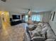 Spacious living room with a sectional sofa and access to hallway at 730 Ne 18Th Ave, Ocala, FL 34470