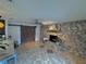 Living area showcasing a stone fireplace and barn door at 730 Ne 18Th Ave, Ocala, FL 34470