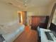 Cozy bedroom featuring a twin bed, wooden wardrobe, and workspace at 730 Ne 18Th Ave, Ocala, FL 34470