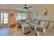 Bright living room featuring a large sectional sofa and tile flooring at 730 Ne 18Th Ave, Ocala, FL 34470