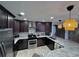 Modern kitchen with dark cabinetry and granite countertops at 730 Ne 18Th Ave, Ocala, FL 34470
