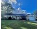 Single-story home with attached garage and well-manicured lawn at 730 Ne 18Th Ave, Ocala, FL 34470