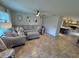 Open living room with a sectional sofa and views into kitchen area at 730 Ne 18Th Ave, Ocala, FL 34470