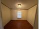 Simple bedroom with wood flooring and a window at 8685 Sw 67 Ct, Ocala, FL 34476