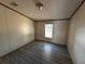 Simple bedroom with wood-look floors and a window at 8685 Sw 67 Ct, Ocala, FL 34476