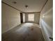 Simple bedroom with carpeted floors and a window at 8685 Sw 67 Ct, Ocala, FL 34476