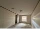 Simple bedroom with carpeted floors and a window at 8685 Sw 67 Ct, Ocala, FL 34476