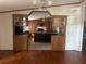 View of kitchen with an island and dark wood cabinets at 8685 Sw 67 Ct, Ocala, FL 34476