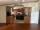 View of kitchen with an island and dark wood cabinets at 8685 Sw 67 Ct, Ocala, FL 34476