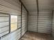 Interior of a metal workshop with tile floor and window at 8685 Sw 67 Ct, Ocala, FL 34476