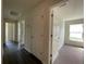 Hallway with doors to bedrooms and carpeted flooring at 2030 Sw 163Rd Pl, Ocala, FL 34473
