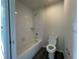 Bathroom with shower/tub combo, toilet and dark grey flooring at 2030 Sw 163Rd Pl, Ocala, FL 34473