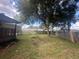 Spacious backyard with large tree and wooden fence at 8685 Sw 67 Ct, Ocala, FL 34476