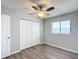 Bedroom with ceiling fan, wood-look floors, and double door closet at 10335 Sw 92Nd Ct, Ocala, FL 34481