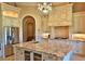 Modern kitchen with granite island, custom cabinetry, and stainless steel appliances at 1525 Se 59Th St, Ocala, FL 34480