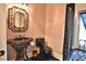 Elegant powder room with a pedestal sink and dark-colored toilet at 1525 Se 59Th St, Ocala, FL 34480