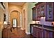 Wet bar with granite countertops, custom cabinetry, and a mini-fridge at 1525 Se 59Th St, Ocala, FL 34480