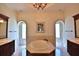 Elegant bathroom with soaking tub, double vanities, and large windows at 1525 Se 59Th St, Ocala, FL 34480