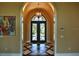 Grand entry with decorative iron doors and diamond patterned tile floor at 1525 Se 59Th St, Ocala, FL 34480