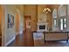 High ceiling living room with hardwood floors, fireplace, and access to other rooms at 1525 Se 59Th St, Ocala, FL 34480