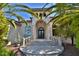 Elegant entryway with arched details, wrought iron doors, and stone steps at 1525 Se 59Th St, Ocala, FL 34480