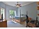 Bedroom with a king-size bed, hardwood floors, and a desk area at 1525 Se 59Th St, Ocala, FL 34480