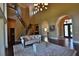 Spacious living area with hardwood floors, curved staircase, and entryway view at 1525 Se 59Th St, Ocala, FL 34480