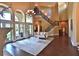 Two story living room with hardwood floors, fireplace, and curved staircase at 1525 Se 59Th St, Ocala, FL 34480