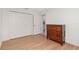 Simple bedroom with double doors and wood floors at 15596 Sw 13Th Cir, Ocala, FL 34473