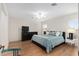 Spacious bedroom with king-size bed, dresser, and hardwood floors at 15596 Sw 13Th Cir, Ocala, FL 34473
