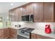 Updated kitchen with wood cabinets, granite countertops, and stainless steel appliances at 15596 Sw 13Th Cir, Ocala, FL 34473