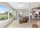 Bright sunroom overlooking the backyard and features wicker furniture at 15596 Sw 13Th Cir, Ocala, FL 34473