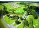 Community entrance with lush landscaping and golf course at 15596 Sw 13Th Cir, Ocala, FL 34473