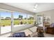 Bright sunroom with wicker furniture and view of golf course at 15596 Sw 13Th Cir, Ocala, FL 34473
