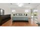 Bright bedroom with king bed, hardwood floors, and sliding door to patio at 15596 Sw 13Th Cir, Ocala, FL 34473