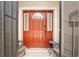 Front door with sidelights and a decorative doormat at 15596 Sw 13Th Cir, Ocala, FL 34473