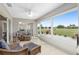 Spacious sunroom with wicker furniture and stunning golf course views at 15596 Sw 13Th Cir, Ocala, FL 34473