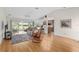 Living room with hardwood floors, sliding glass doors and open concept kitchen at 15596 Sw 13Th Cir, Ocala, FL 34473