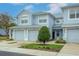 Two-story townhome with two-car garage and landscaped front yard at 4555 Sw 52Nd Cir # 101, Ocala, FL 34474