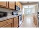 Eat-in kitchen with stainless steel appliances and view to the dining area at 4555 Sw 52Nd Cir # 101, Ocala, FL 34474